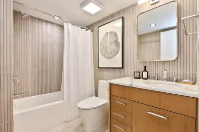 a bathroom with a sink and a toilet and a mirror at Home at Camelback Mtn with Game Room near Waterparks in Tannersville