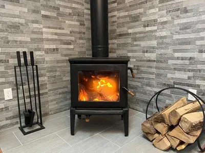 a stove in a room with a brick wall at Home at Camelback Mtn with Game Room near Waterparks in Tannersville