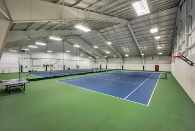 a tennis court in a building with two tennis courts at Home at Camelback Mtn with Game Room near Waterparks in Tannersville