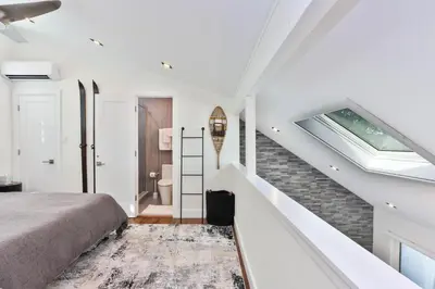 a bedroom with a bed and a staircase at Home at Camelback Mtn with Game Room near Waterparks in Tannersville