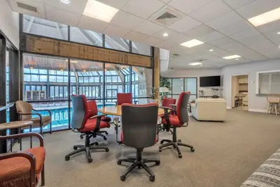 a conference room with a table and chairs and a pool at Home at Camelback Mtn with Game Room near Waterparks in Tannersville