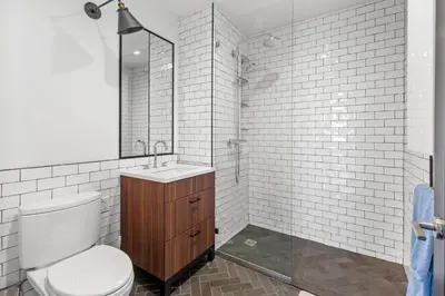 a bathroom with a toilet and a sink and a mirror at Brooklyn with a View in New York