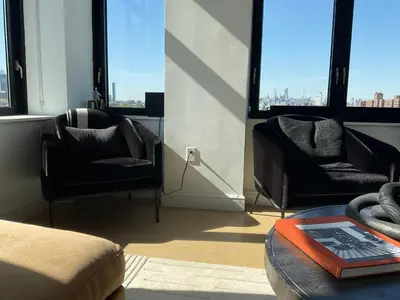 a room with two chairs and a table and windows at Brooklyn with a View in New York