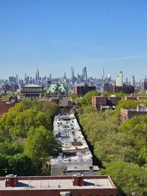 a row of boats parked in a river with a city at Brooklyn with a View in New York