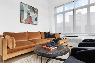 a living room with a couch and a table at Brooklyn with a View in New York