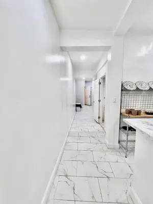 an empty hallway with white walls and marble floors at f and R in Philadelphia