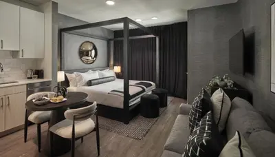 a hotel room with a bed and a table at Luxury Apartments by Hyatus Center City in Philadelphia