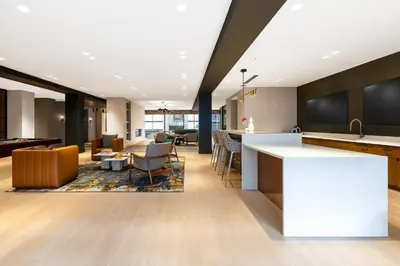 an open kitchen and living room with a bar at Luxury Apartments by Hyatus Center City in Philadelphia