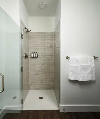 a bathroom with a shower with a glass door at Luxury Apartments by Hyatus Center City in Philadelphia