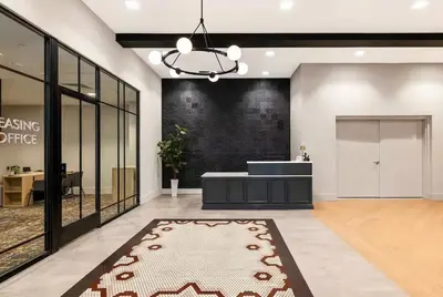 a lobby with a reception desk and a rug at Luxury Apartments by Hyatus Center City in Philadelphia