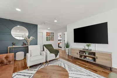 a living room with a flat screen tv on a wall at NYC 20min, Sleeps 10, Free Parking, Patio in Bayonne