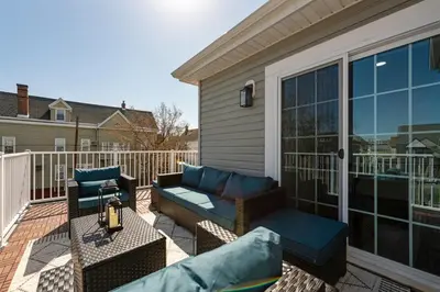 a patio with a couch and chairs on a balcony at NYC 20min, Sleeps 10, Free Parking, Patio in Bayonne