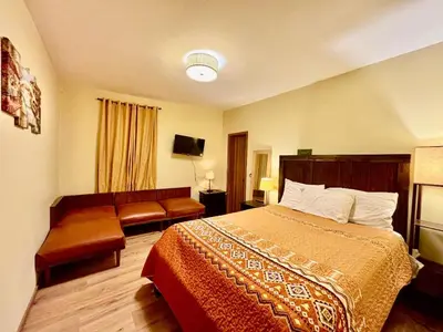 a hotel room with a bed and a couch at Penn Station Room Motel Casa in Newark
