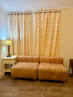 a living room with a couch and a table at Penn Station Room Motel Casa in Newark