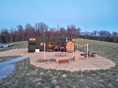 a small cabin in a field next to a field at The Retreat on the Ranch (INSANE VIEW) in Gap