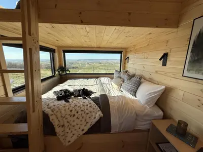 a bedroom with a bed in a log cabin at The Retreat on the Ranch (INSANE VIEW) in Gap