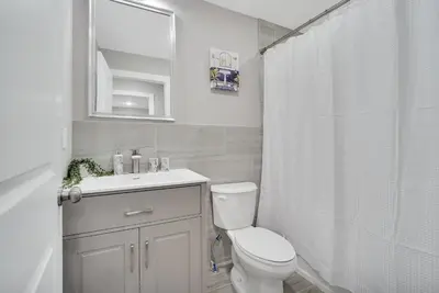 a bathroom with a toilet and a sink and a shower at Your home away from home in Newark
