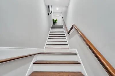 a staircase in a house with a potted plant at Your home away from home in Newark