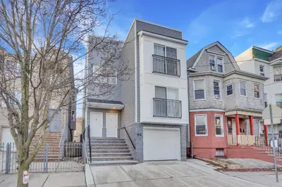 a row of houses on a city street at Your home away from home in Newark