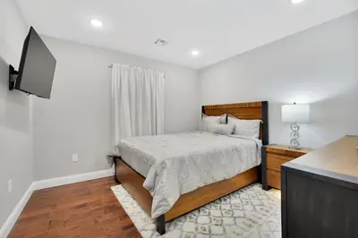 a bedroom with a bed and a flat screen tv at Home away from home 2 in Newark