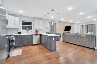 an open kitchen and living room with a couch at Home away from home 2 in Newark