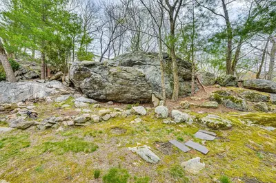 a pile of rocks and a large boulder in a forest at Home 2 Mi to Thayer Gate at U S Military Academy in Highland Falls