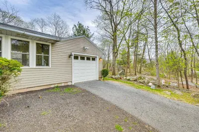 a house with a white garage and a driveway at Home 2 Mi to Thayer Gate at U S Military Academy in Highland Falls