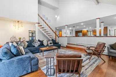 a living room with a blue couch and chairs at Spacious Game Room Seclusion Hot Tub and more in Long Pond