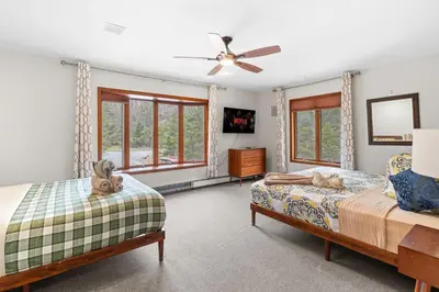 a bedroom with two beds and a ceiling fan at Spacious Game Room Seclusion Hot Tub and more in Long Pond