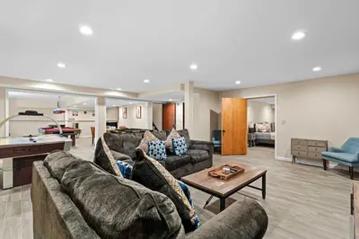 a living room with a couch and a table at Spacious Game Room Seclusion Hot Tub and more in Long Pond