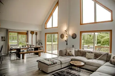 a living room with a couch and a table at Incredible New York Cabin with a Spa and Movie Theater in Livingston Manor
