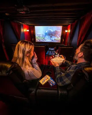 a man and a woman sitting in a train at Incredible New York Cabin with a Spa and Movie Theater in Livingston Manor