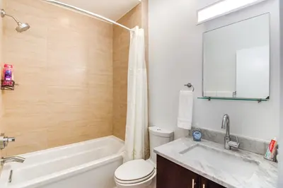 a bathroom with a tub and a toilet and a sink at 1 Mi to Old Town Philadelphia Townhome with Patio! in Philadelphia
