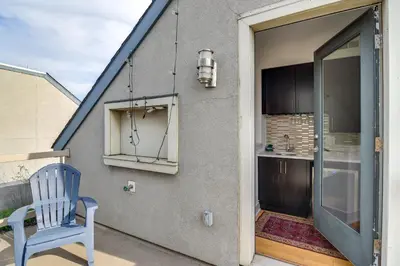 a blue chair sitting on a patio with a kitchen at 1 Mi to Old Town Philadelphia Townhome with Patio! in Philadelphia