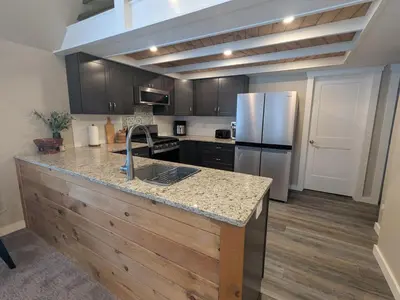 a kitchen with a refrigerator and a counter top at Cabin with Sauna Close to Skiing in Arrowhead Lake