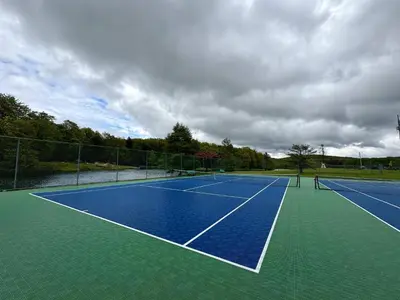 a tennis court with two people on it at Cabin with Sauna Close to Skiing in Arrowhead Lake