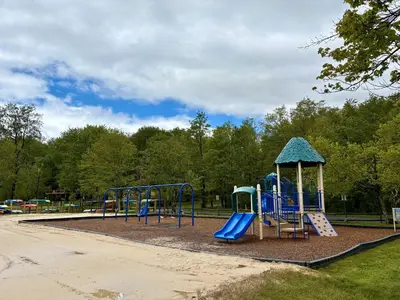 a playground with a blue slide and a gazebo at Cabin with Sauna Close to Skiing in Arrowhead Lake