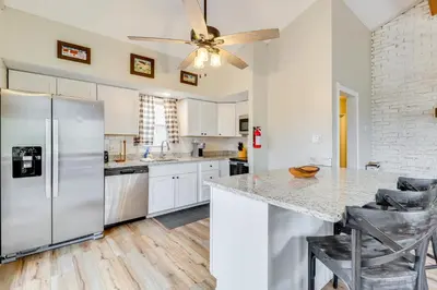 a kitchen with white appliances and a ceiling fan at Beach Access BBQ-Ready Poconos Family Getaway! in Blakeslee