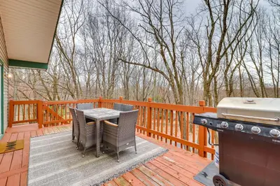 a patio with a table and a grill on a deck at Beach Access BBQ-Ready Poconos Family Getaway! in Blakeslee