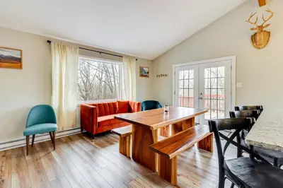 a living room with a table and chairs at Beach Access BBQ-Ready Poconos Family Getaway! in Blakeslee