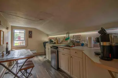 a small kitchen with a sink and a table at Heart of Historic Wurtsboro Suite 6 in Wurtsboro
