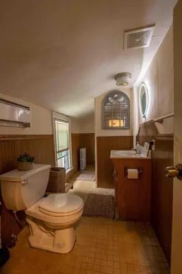 a bathroom with a toilet and a sink at Heart of Historic Wurtsboro Suite 6 in Wurtsboro