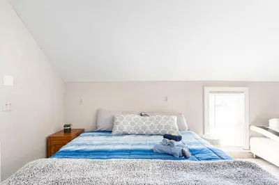 a bedroom with a bed with a teddy bear on it at Heart of Historic Wurtsboro Suite 6 in Wurtsboro