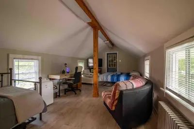 a bedroom with a bed and a desk in a room at Heart of Historic Wurtsboro Suite 6 in Wurtsboro