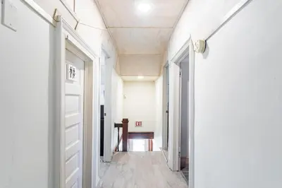 a hallway with a white door and a table at Heart of Historic Wurtsboro Suite 6 in Wurtsboro