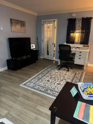a living room with a television and a table at Countryside Comfort in Willseyville