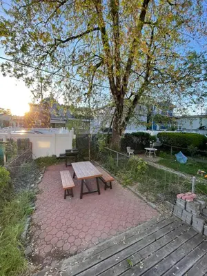 a picnic table and benches on a brick patio at 4 ROOMS FAMILY HOUSE WITH BACKYARD, LAUNDRY AND PARKINg in Union City