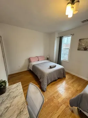 a bedroom with a bed with pink pillows on it at 4 ROOMS FAMILY HOUSE WITH BACKYARD, LAUNDRY AND PARKINg in Union City
