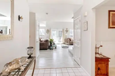 a living room with white walls and a hallway at Hilltop Villa in East Stroudsburg