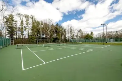 a tennis court with two tennis rackets on it at Hilltop Villa in East Stroudsburg